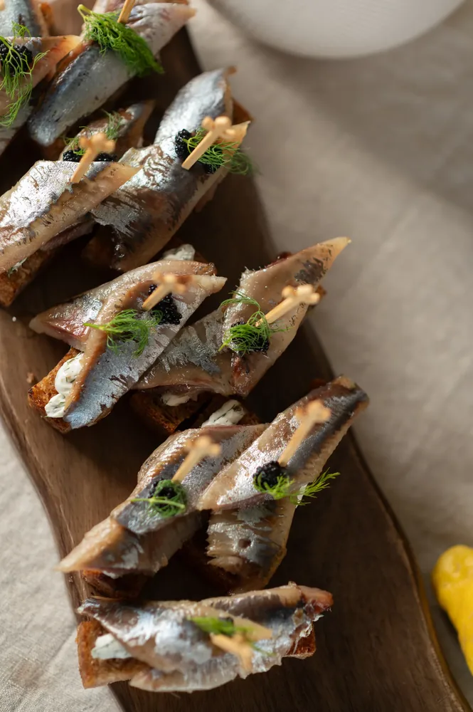 Seafood canapes on a wooden board