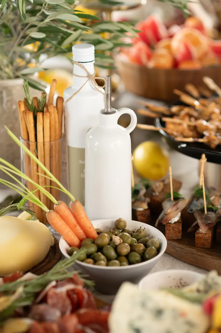 Catering spread with olives, oil and canapes